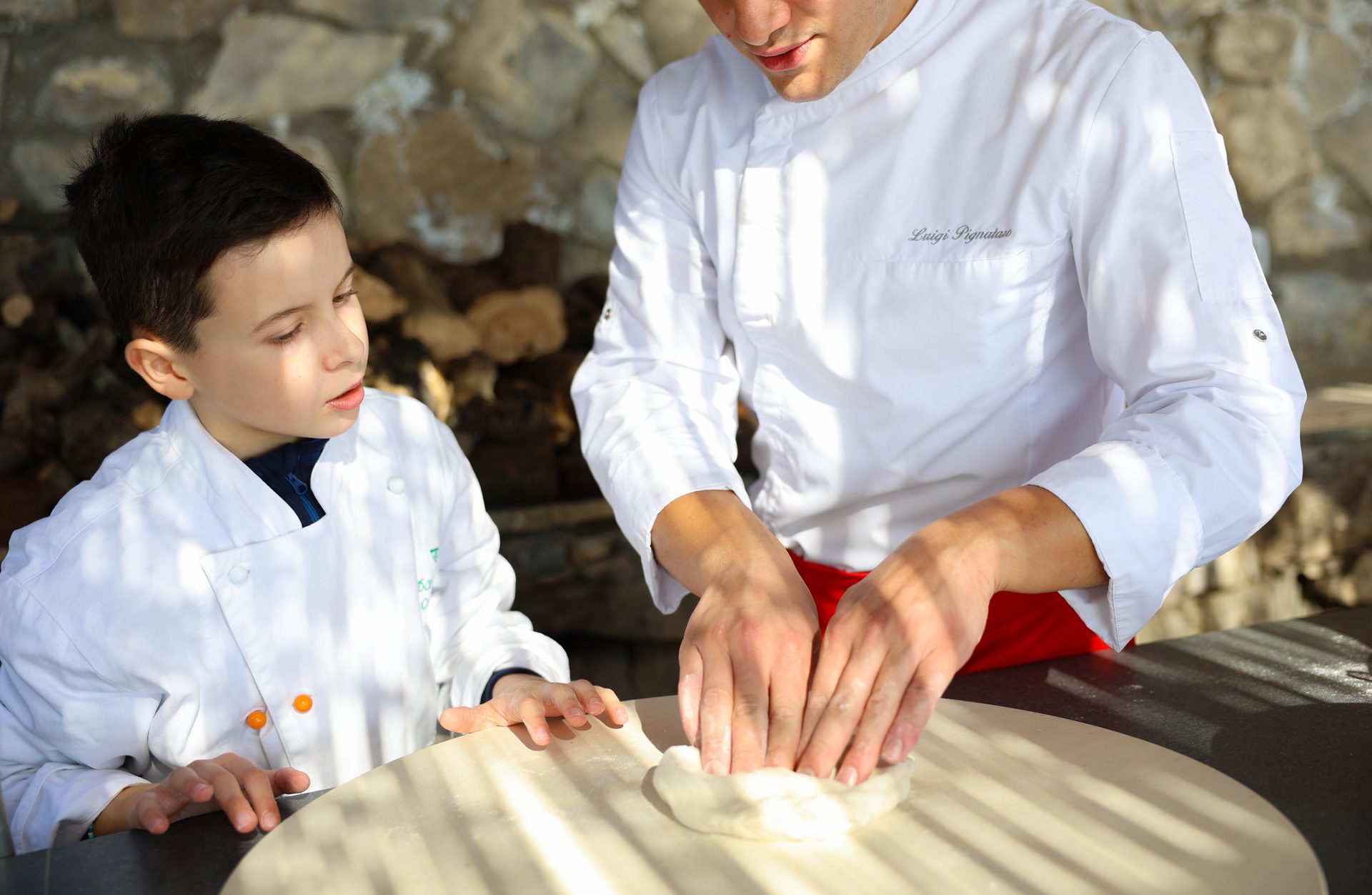 I bambini imparano a preparare la pizza con lo chef
